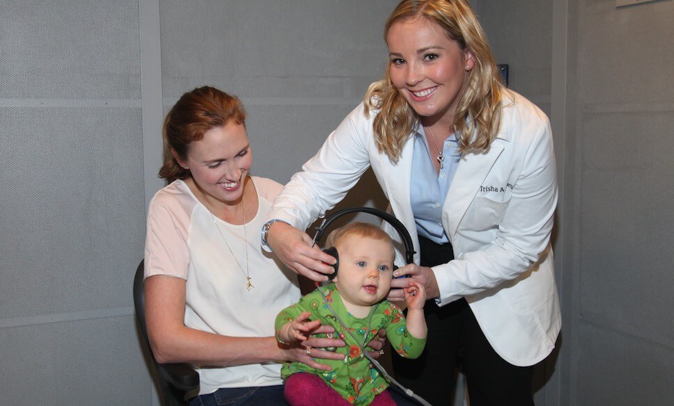Dr. Trisha Muth Conducting Hearing Test on Young Child