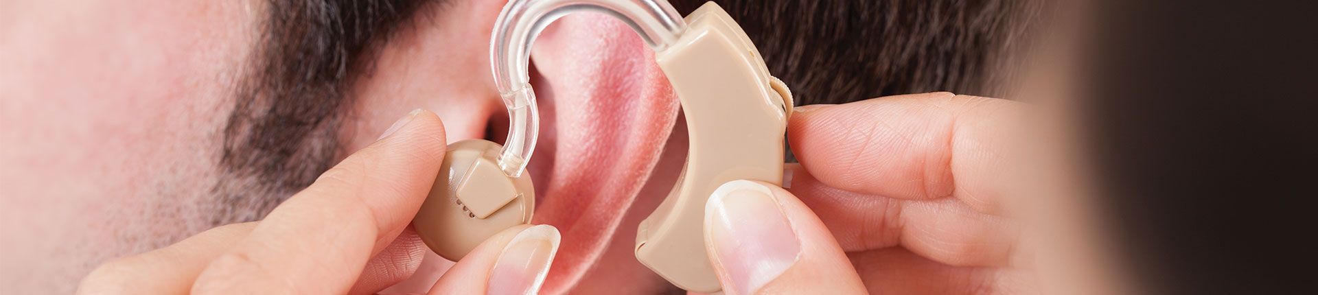 Doctor Adjusting Hearing Aid